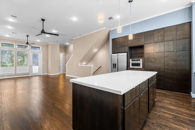 3115 Leeland St, Houston, TX 77003 - kitchen featuring appliances with stainless steel finishes, ornamental molding, a ceiling fan, dark wood-style flooring, and dark brown cabinets