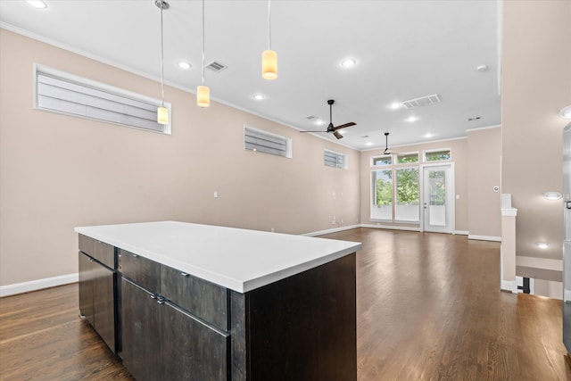 3115 Leeland St, Houston, TX 77003 - kitchen featuring ceiling fan, crown molding, baseboards, a center island, and dark wood-type flooring