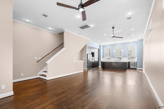 3115 Leeland St, Houston, TX 77003 - unfurnished living room featuring a ceiling fan, dark wood-type flooring, baseboards, crown molding, and recessed lighting