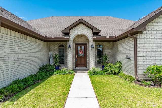 3314 Bastian Rd, Dickinson, TX 77539 - entrance to property with brick siding, a yard, and roof with shingles