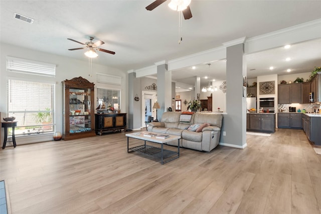 3314 Bastian Rd, Dickinson, TX 77539 - living room with ceiling fan, light wood finished floors, ornate columns, and baseboards