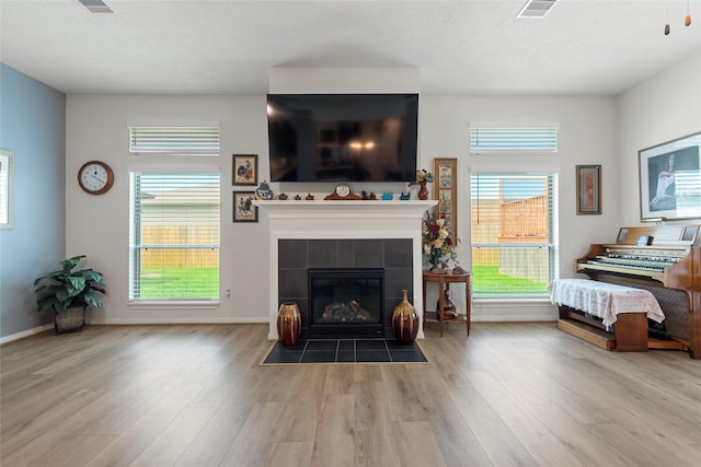 3314 Bastian Rd, Dickinson, TX 77539 - living room featuring wood finished floors, baseboards, and a fireplace
