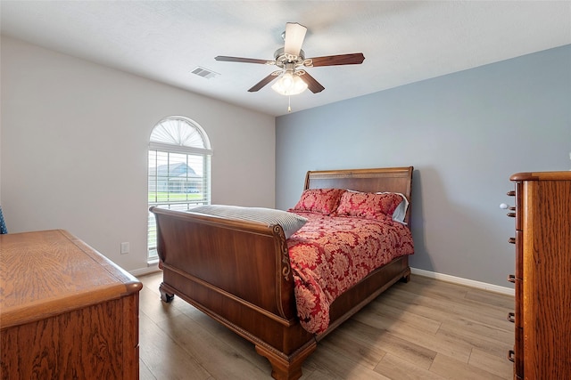 3314 Bastian Rd, Dickinson, TX 77539 - bedroom with light wood finished floors, baseboards, and a ceiling fan