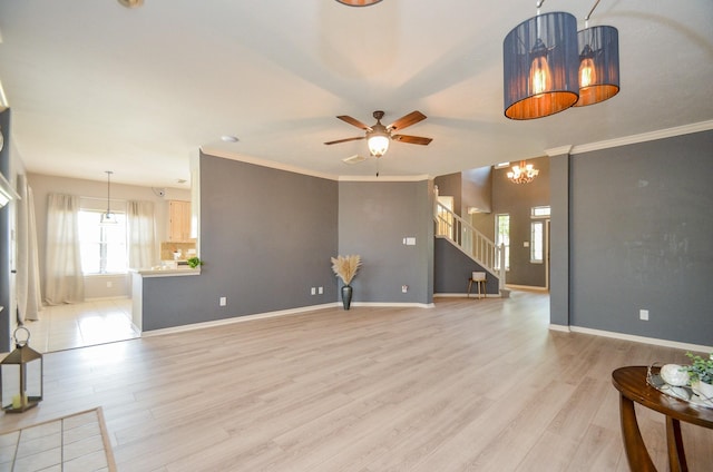 415 Wild Peach Pl, Missouri City, TX 77459 - unfurnished living room featuring light wood-style flooring, ceiling fan, stairway, baseboards, and crown molding