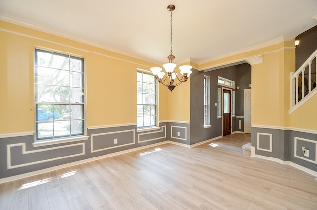415 Wild Peach Pl, Missouri City, TX 77459 - unfurnished dining area with a chandelier, a wainscoted wall, crown molding, and wood finished floors