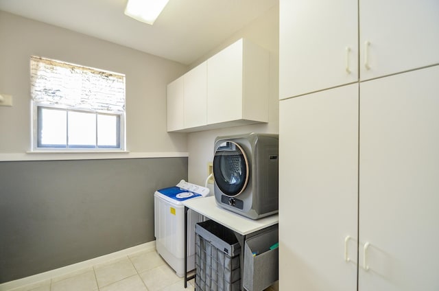 415 Wild Peach Pl, Missouri City, TX 77459 - laundry area featuring cabinet space, washer / clothes dryer, baseboards, and light tile patterned flooring