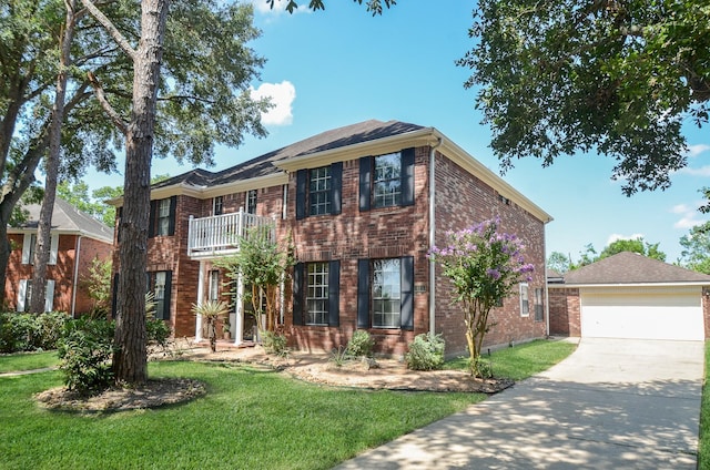 415 Wild Peach Pl, Missouri City, TX 77459 - colonial home featuring a balcony, a front lawn, brick siding, driveway, and an outbuilding