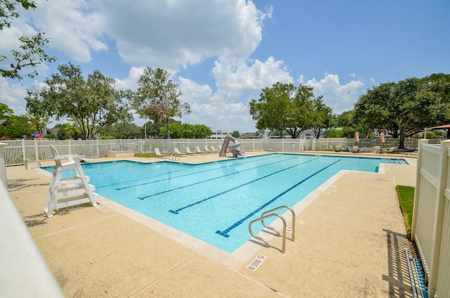 415 Wild Peach Pl, Missouri City, TX 77459 - community pool featuring fence, a water slide, and a patio