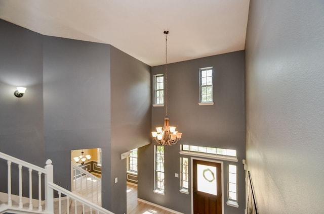 415 Wild Peach Pl, Missouri City, TX 77459 - foyer entrance with a chandelier, a high ceiling, and wood finished floors