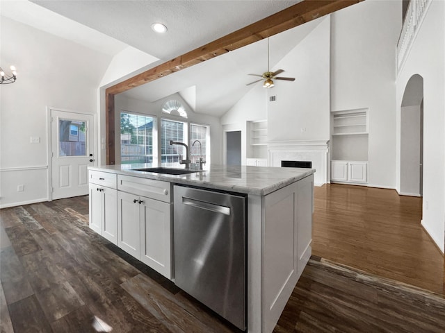 22014 Mission Hills Ln, Katy, TX 77450 - kitchen with stainless steel dishwasher, a sink, built in shelves, a center island with sink, and a ceiling fan