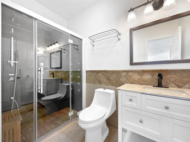 22014 Mission Hills Ln, Katy, TX 77450 - full bathroom featuring tile walls, toilet, vanity, a stall shower, and a wainscoted wall