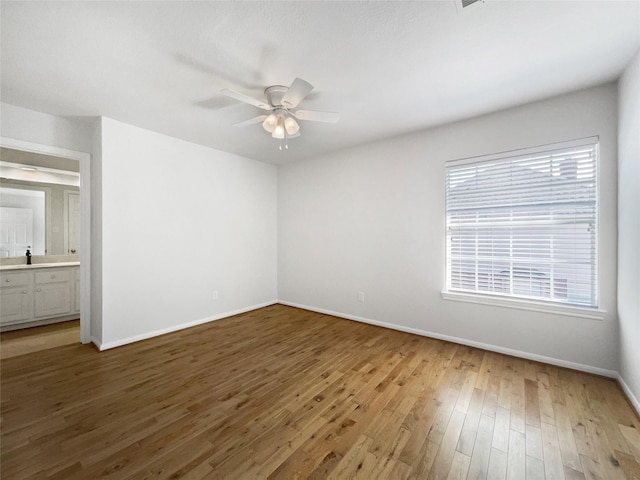 22014 Mission Hills Ln, Katy, TX 77450 - unfurnished bedroom with baseboards, wood finished floors, connected bathroom, and a ceiling fan