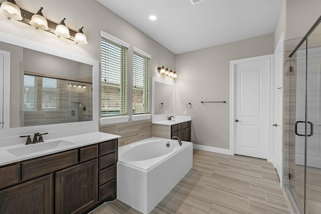 1810 Evergreen Bay Ln, Katy, TX 77494 - full bathroom featuring a shower stall, two vanities, a bath, and baseboards