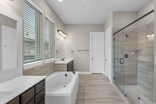 1810 Evergreen Bay Ln, Katy, TX 77494 - full bathroom with plenty of natural light, a stall shower, two vanities, and a garden tub