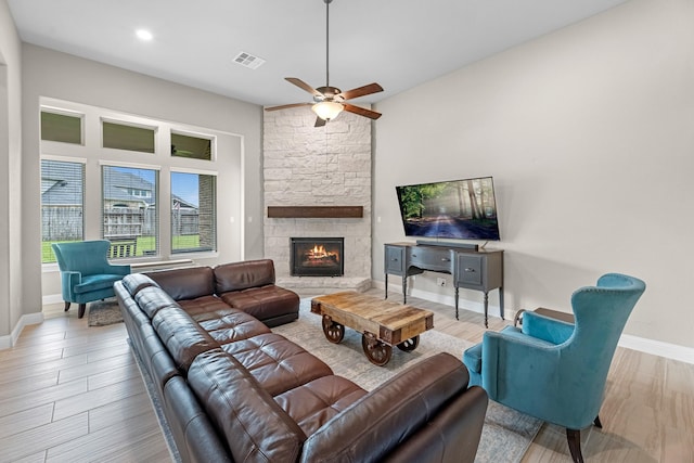 1810 Evergreen Bay Ln, Katy, TX 77494 - living area with wood finished floors, baseboards, ceiling fan, and a stone fireplace