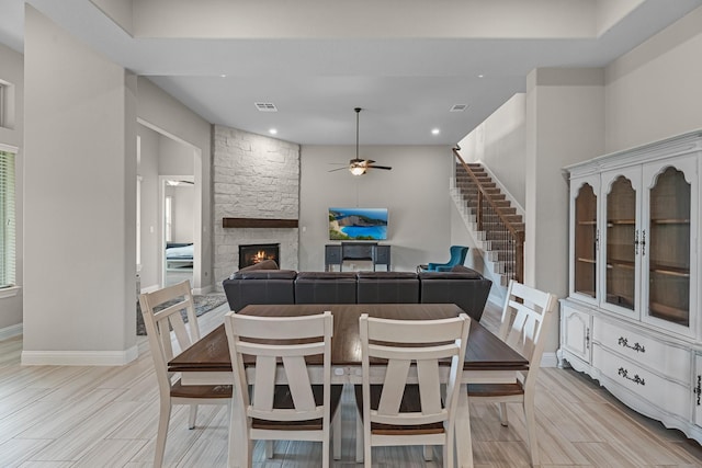 1810 Evergreen Bay Ln, Katy, TX 77494 - dining space with ceiling fan, a stone fireplace, baseboards, stairway, and recessed lighting