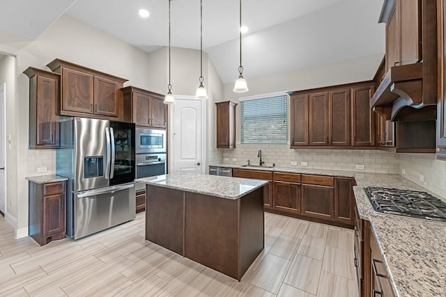 1810 Evergreen Bay Ln, Katy, TX 77494 - kitchen with stainless steel appliances, tasteful backsplash, lofted ceiling, a kitchen island, and light stone counters