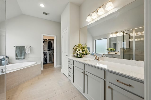 1722 Country Air Ln, Missouri City, TX 77459 - full bathroom featuring vanity, a shower stall, a bath, a spacious closet, and high vaulted ceiling