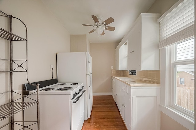 kitchen featuring white appliances, decorative backsplash, a ceiling fan, white cabinets, and wood finished floors
