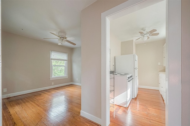 hall with light wood finished floors and baseboards