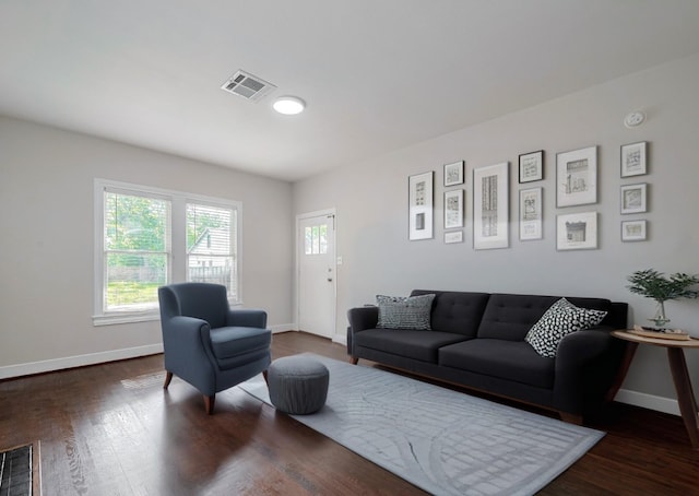 living room featuring baseboards and wood finished floors