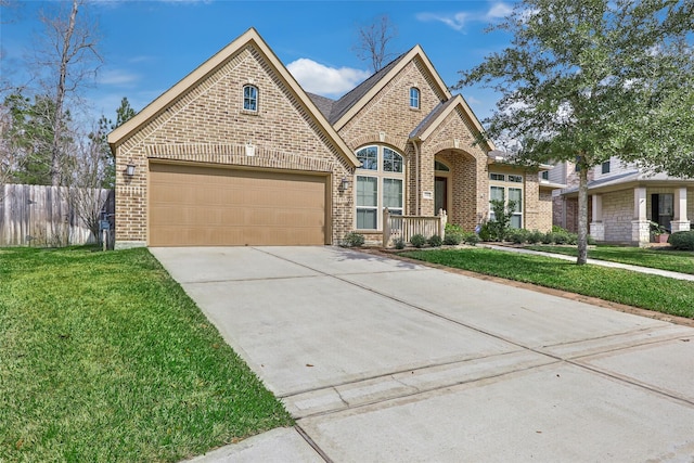 23335 Robinson Pond Dr, New Caney, TX 77357 - french country style house featuring brick siding, driveway, and an attached garage