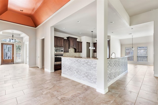 23335 Robinson Pond Dr, New Caney, TX 77357 - entrance foyer featuring a chandelier, arched walkways, baseboards, light tile patterned floors, and recessed lighting