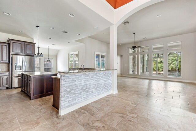 23335 Robinson Pond Dr, New Caney, TX 77357 - kitchen featuring stainless steel refrigerator with ice dispenser, a center island, ceiling fan, dark brown cabinets, and recessed lighting
