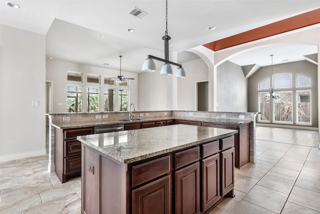 23335 Robinson Pond Dr, New Caney, TX 77357 - kitchen with a center island, a sink, recessed lighting, a ceiling fan, and tasteful backsplash