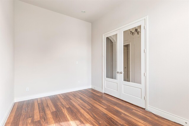 23335 Robinson Pond Dr, New Caney, TX 77357 - unfurnished bedroom with french doors, wood finished floors, and baseboards