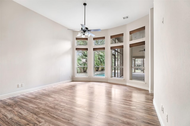 23335 Robinson Pond Dr, New Caney, TX 77357 - unfurnished dining area featuring ceiling fan, wood finished floors, and baseboards