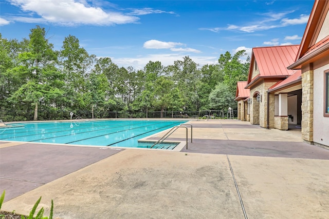 23335 Robinson Pond Dr, New Caney, TX 77357 - community pool featuring a patio, fence, and view of wooded area