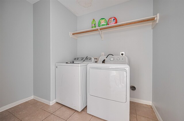 4918 Alder Bend Ln, Richmond, TX 77469 - washroom with washer and dryer, light tile patterned flooring, and baseboards