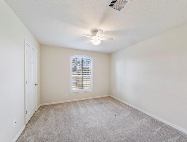 14414 Spring Mountain Dr, Tomball, TX 77377 - spare room featuring ceiling fan, light colored carpet, baseboards, and a textured ceiling