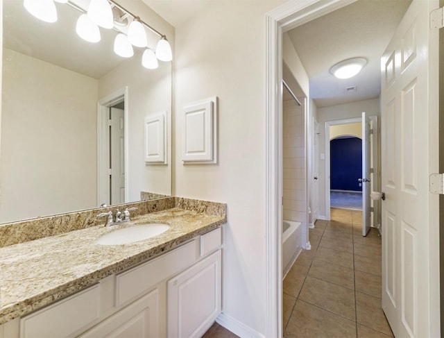 14414 Spring Mountain Dr, Tomball, TX 77377 - full bathroom with tile patterned flooring, vanity, baseboards, and  shower combination