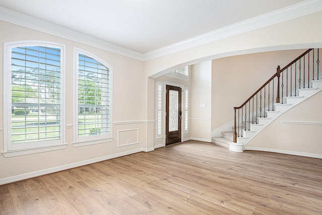 14414 Spring Mountain Dr, Tomball, TX 77377 - entryway with stairway, light wood finished floors, arched walkways, ornamental molding, and baseboards