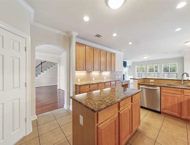 14414 Spring Mountain Dr, Tomball, TX 77377 - kitchen featuring a sink, dishwasher, light tile patterned floors, a center island, and dark stone counters