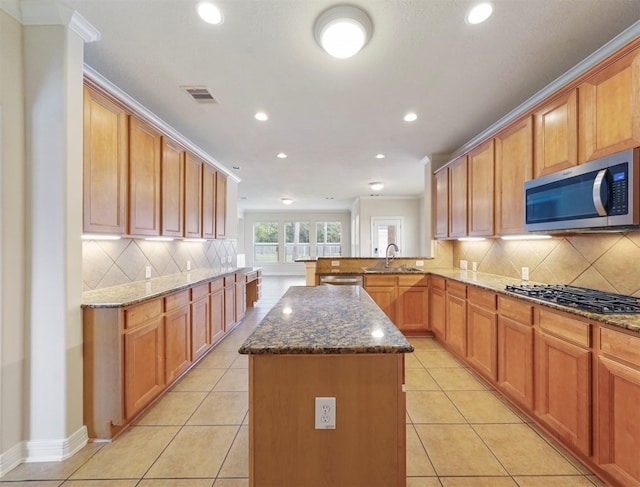 14414 Spring Mountain Dr, Tomball, TX 77377 - kitchen with stainless steel appliances, a sink, recessed lighting, a kitchen island, and dark stone countertops
