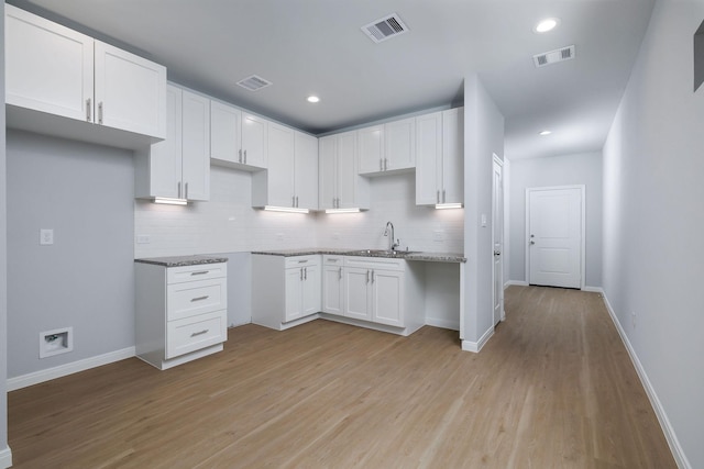 18832 Elegance Ave, Spring, TX 77379 - kitchen with a sink, decorative backsplash, light wood-style flooring, baseboards, and recessed lighting