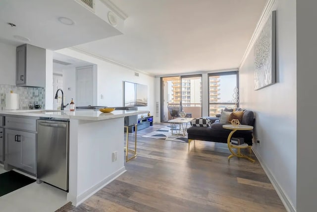 3525 Sage Rd Unit 1105, Houston, TX 77056 - kitchen featuring stainless steel dishwasher, gray cabinetry, open floor plan, light countertops, and wood finished floors