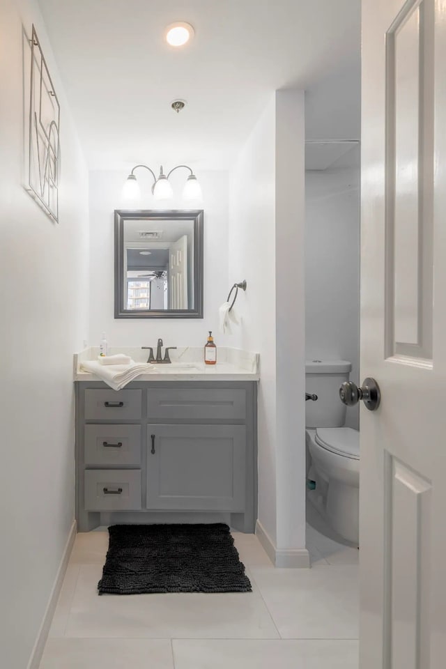3525 Sage Rd Unit 1105, Houston, TX 77056 - bathroom with toilet, baseboards, vanity, and tile patterned flooring