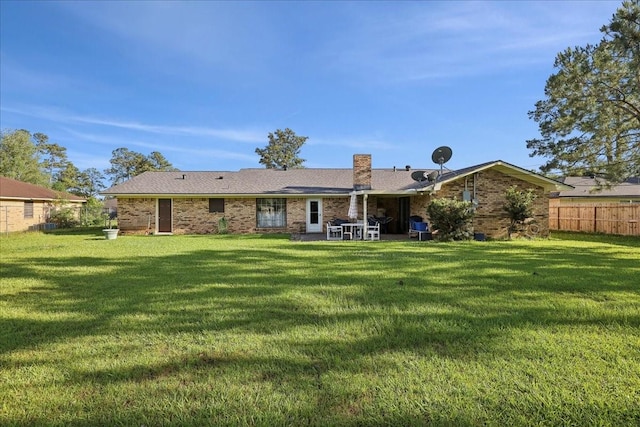 7760 Laurie Ln, Lumberton, TX 77657 - rear view of house with brick siding and a patio