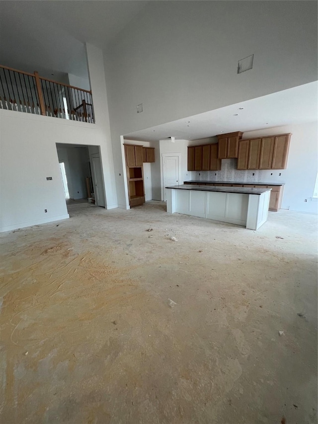 2213 Sonder Shore Dr, Katy, TX 77493 - unfurnished living room featuring a towering ceiling and baseboards