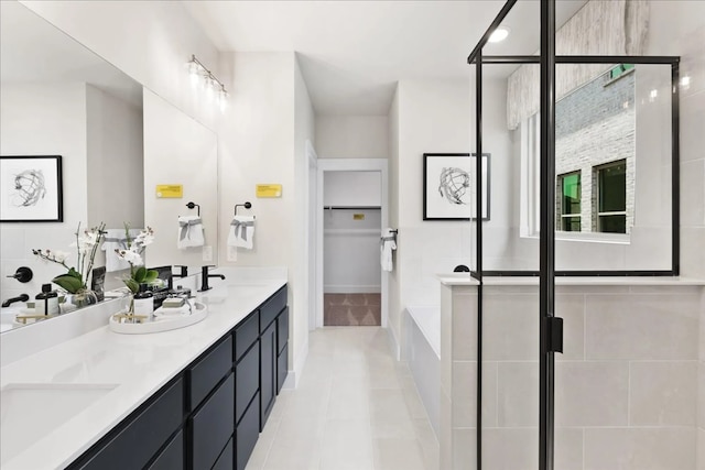 2213 Sonder Shore Dr, Katy, TX 77493 - bathroom with tile patterned floors, a shower stall, a walk in closet, double vanity, and a garden tub