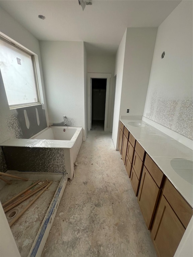 2213 Sonder Shore Dr, Katy, TX 77493 - bathroom featuring a bath, a spacious closet, and double vanity