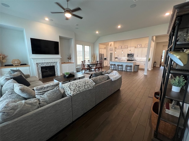 7426 Water Glen Ln, Manvel, TX 77578 - living room featuring dark wood finished floors, a ceiling fan, a tiled fireplace, recessed lighting, and baseboards