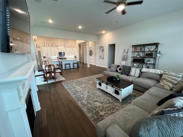 7426 Water Glen Ln, Manvel, TX 77578 - living area featuring a ceiling fan, dark wood-type flooring, arched walkways, recessed lighting, and baseboards