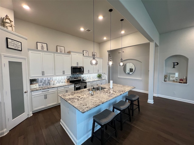 7426 Water Glen Ln, Manvel, TX 77578 - kitchen with appliances with stainless steel finishes, dark wood-style flooring, white cabinets, light stone countertops, and a high ceiling
