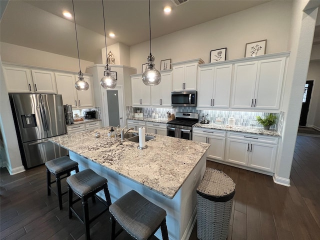 7426 Water Glen Ln, Manvel, TX 77578 - kitchen with appliances with stainless steel finishes, white cabinets, tasteful backsplash, dark wood-type flooring, and recessed lighting
