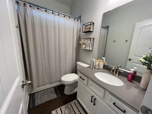 7426 Water Glen Ln, Manvel, TX 77578 - full bathroom with toilet, vanity, wood finished floors, shower / tub combo with curtain, and a textured wall